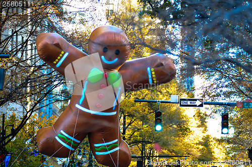 Image of ginger bread cookie inflatable floating thru city streets