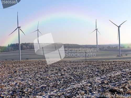 Image of wind wheels with rainbow