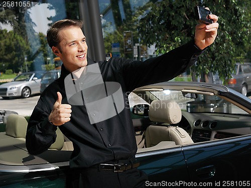 Image of guy taking photo with cellphone a