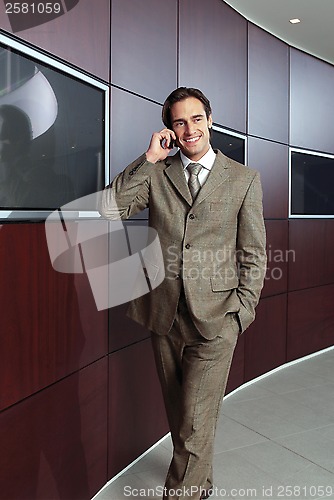 Image of Businessman with mobile phone h