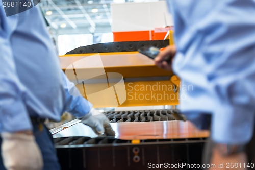 Image of Machine cutting steel in a factory