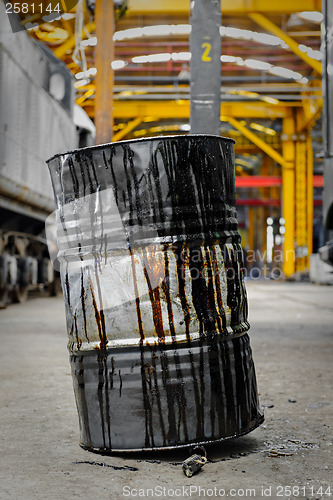 Image of Damaged oil drums in industrial interior