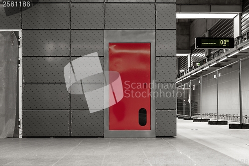 Image of Gray steel wall with the red door
