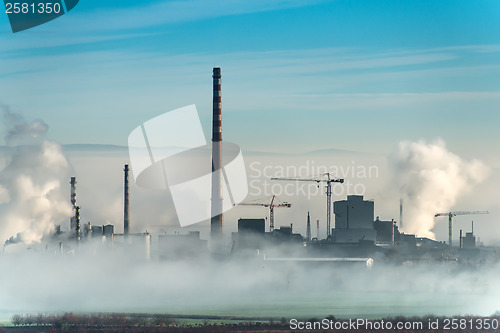 Image of Factory chimneys and clouds of steam