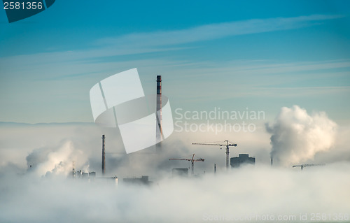 Image of Factory chimneys and clouds of steam