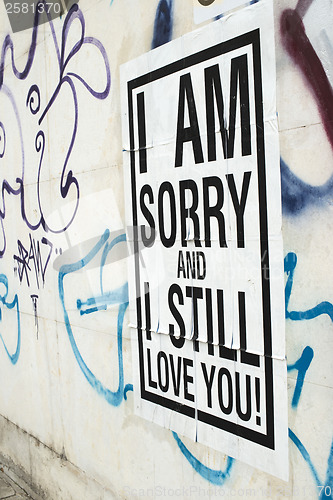 Image of Text poster glued to the wall. I love You.