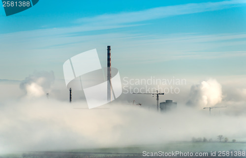 Image of Factory chimneys and clouds of steam