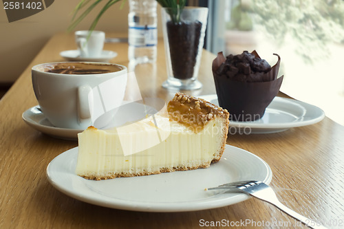 Image of Cheesecake, muffin, coffee and mineral water