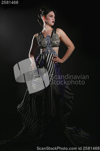 Image of Woman Wearing Striped Fashion With Dramatic Lighting 