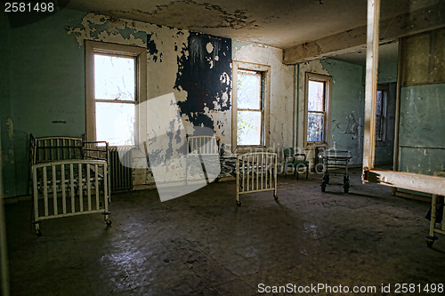 Image of Delapidated Hospital Building With Empty Rusted Beds