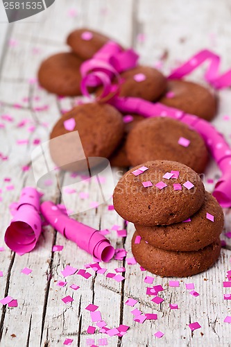 Image of fresh chocolate cookies, coffee beans, pink ribbons and confetti