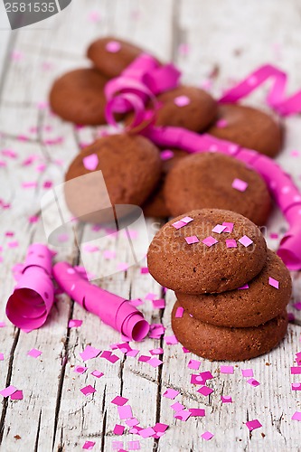 Image of fresh chocolate cookies, coffee beans, pink ribbons and confetti