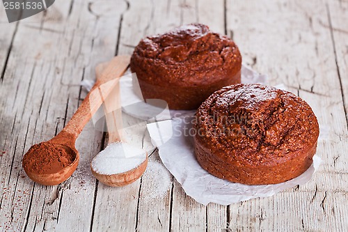 Image of fresh baked browny cakes, sugar and cocoa powder