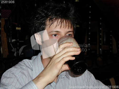 Image of Man drinking a pint of beer