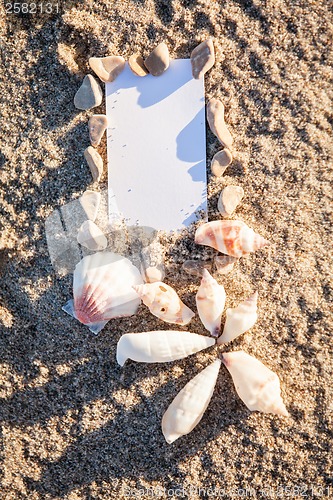 Image of sailing boat and seashell in sand decoration closeup