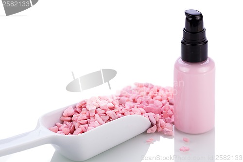 Image of pink body lotion in dispenser and aroma salt isolated