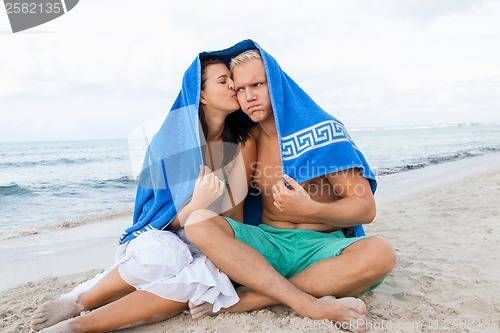 Image of Cheerful couple with a towel covering their heads