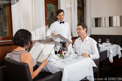 Image of young smiling couple at the restaurant 