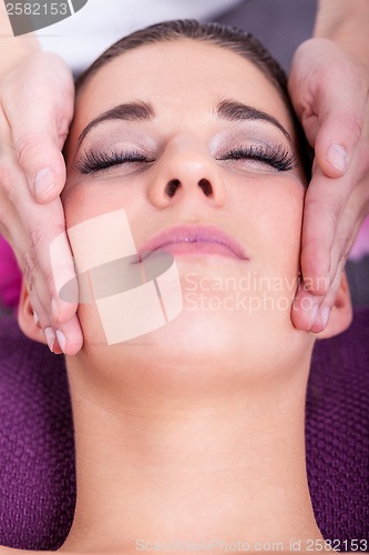 Image of Woman having a relaxing facial massage