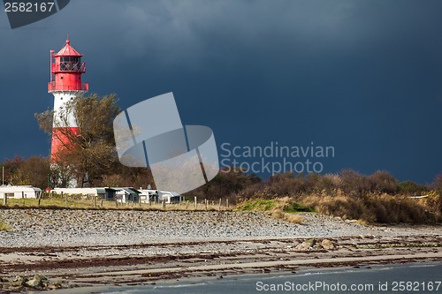 Image of landscape baltic sea dunes lighthouse in red and white 