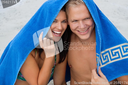 Image of Cheerful couple with a towel covering their heads
