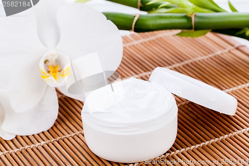 Image of cosmetic face cream on wooden background 