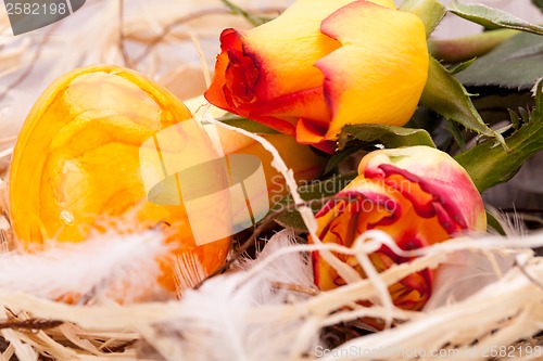 Image of Vivid orange Easter egg with a gerbera and rose