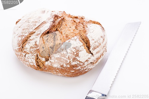 Image of fresh baked grain bead and knife isolated