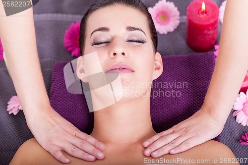 Image of Woman having a relaxing facial massage