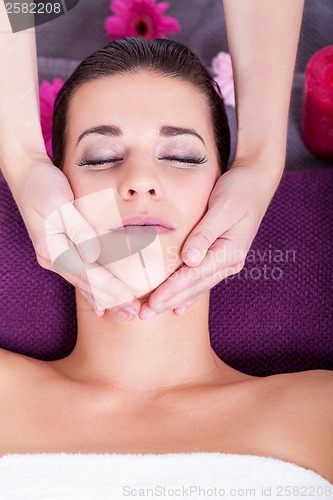 Image of Woman having a relaxing facial massage