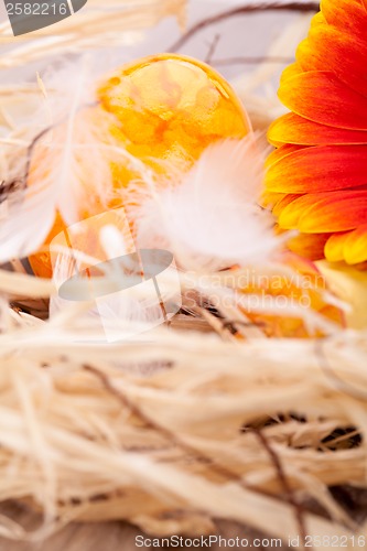 Image of Vivid orange Easter egg with a gerbera and rose