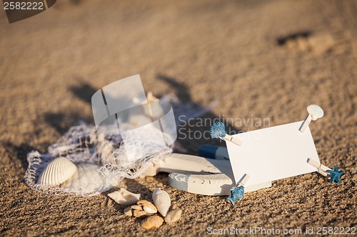 Image of sailing boat and seashell in sand decoration closeup