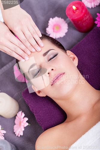 Image of Woman having a relaxing facial massage
