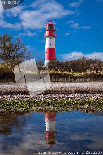 Image of landscape baltic sea dunes lighthouse in red and white 