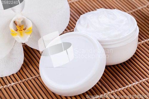 Image of cosmetic face cream on wooden background 
