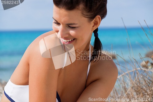 Image of Beautiful young woman in a bikini on the beach