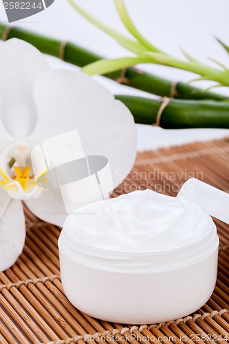 Image of cosmetic face cream on wooden background 