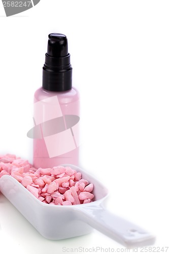 Image of pink body lotion in dispenser and aroma salt isolated