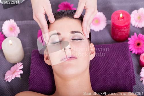 Image of Woman having a relaxing facial massage