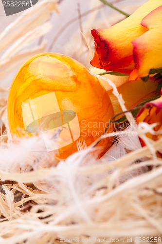 Image of Vivid orange Easter egg with a gerbera and rose