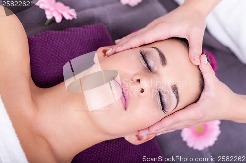 Image of Woman having a relaxing facial massage