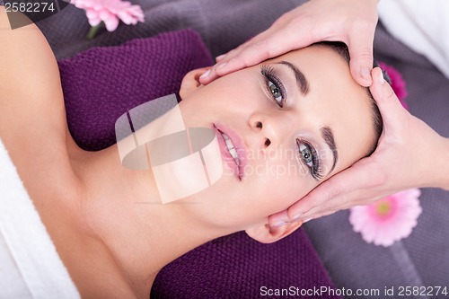 Image of Woman having a relaxing facial massage