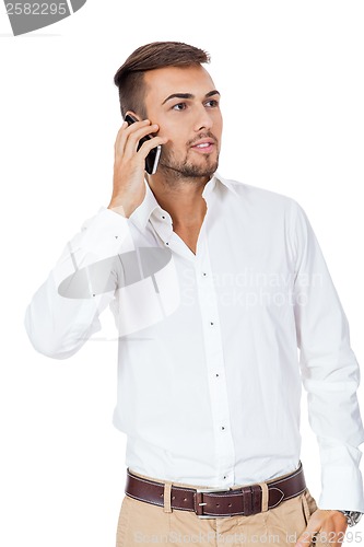 Image of Handsome man reading a message on his mobile