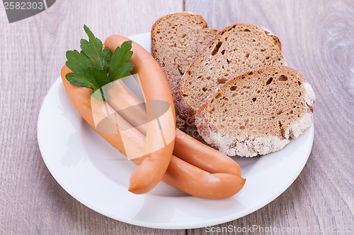 Image of tasty sausages frankfurter with grain bread 