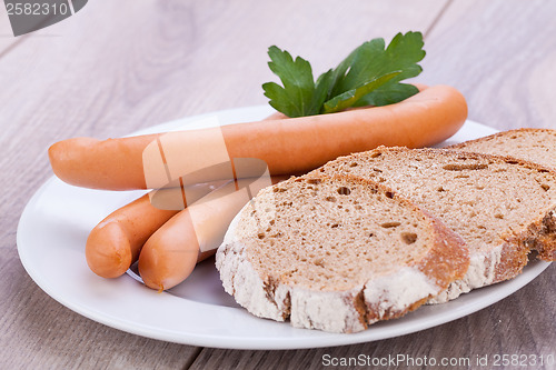 Image of tasty sausages frankfurter with grain bread 