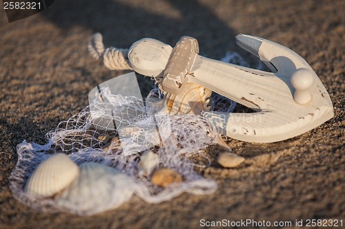 Image of sailing boat and seashell in sand decoration closeup