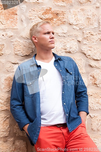 Image of attractive young adult man standing outside 