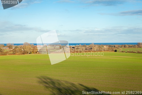 Image of beautiful landscape in autum baltic see green field blue sky