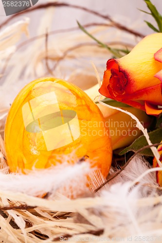 Image of Vivid orange Easter egg with a gerbera and rose