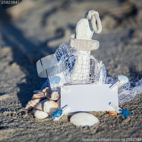 Image of sailing boat and seashell in sand decoration closeup